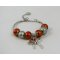 Zilveren armband met oranje kralen en strik